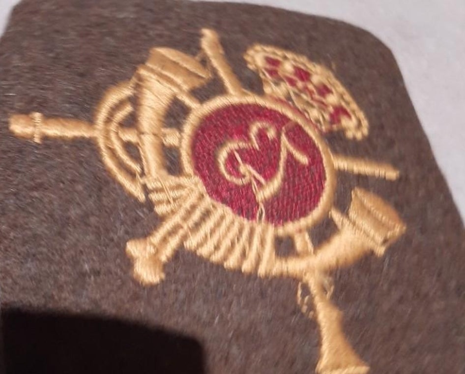 Escudo de tela para manta de capa.